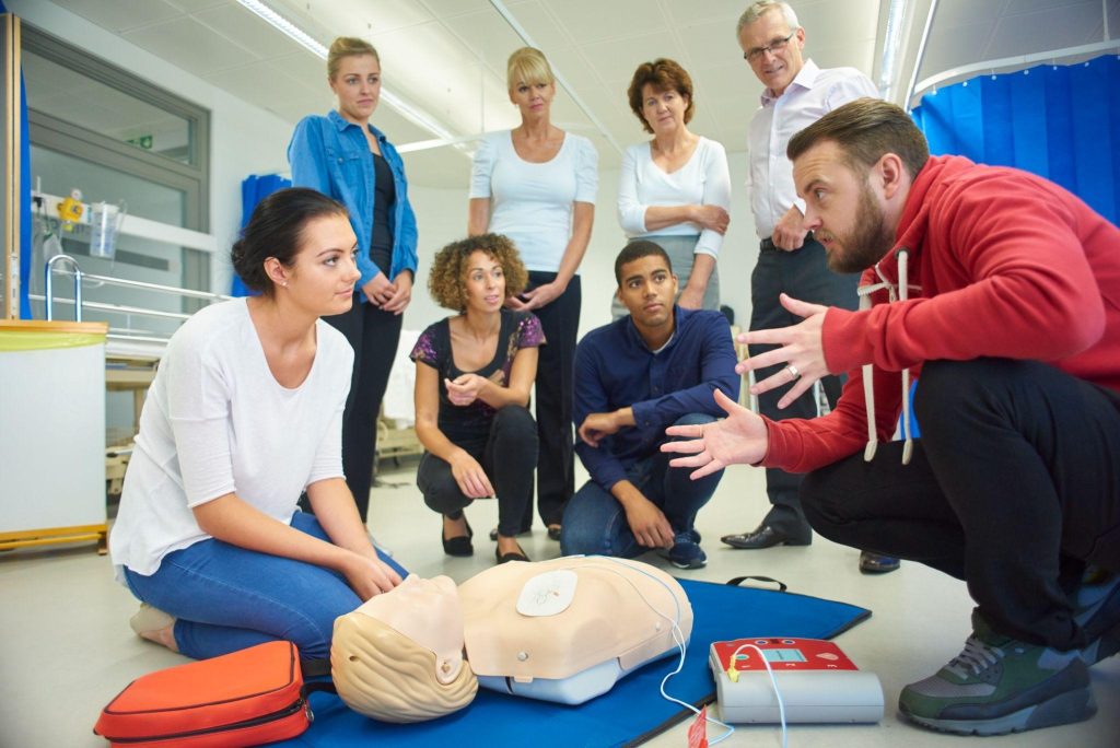 a mixed-age group receiving first aid training